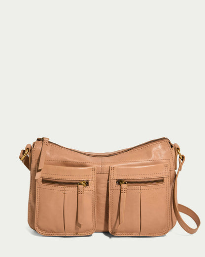 Discover the Holton Crossbody by American Leather Co.: a stylish bag in nutmeg glove leather, featuring two front zippered pockets and gold-tone hardware. Its sleek, structured design with an adjustable strap makes it ideal for any occasion against a simple backdrop.