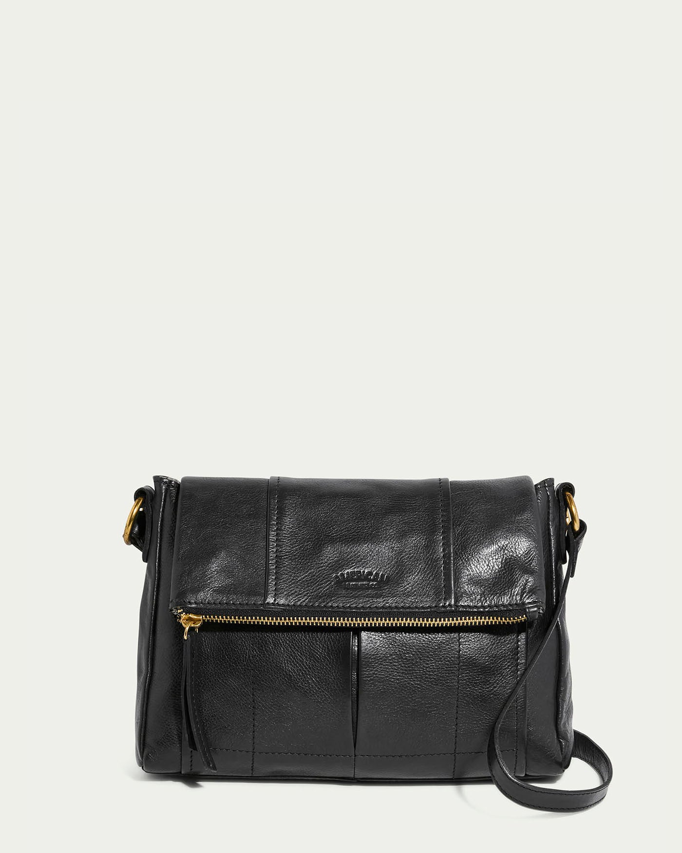 The Lee Double Entry Crossbody by American Leather Co. in black features gold-tone hardware, a front zipper pocket, and an adjustable strap for comfort, offering a sleek and minimal design suitable for versatile styling.