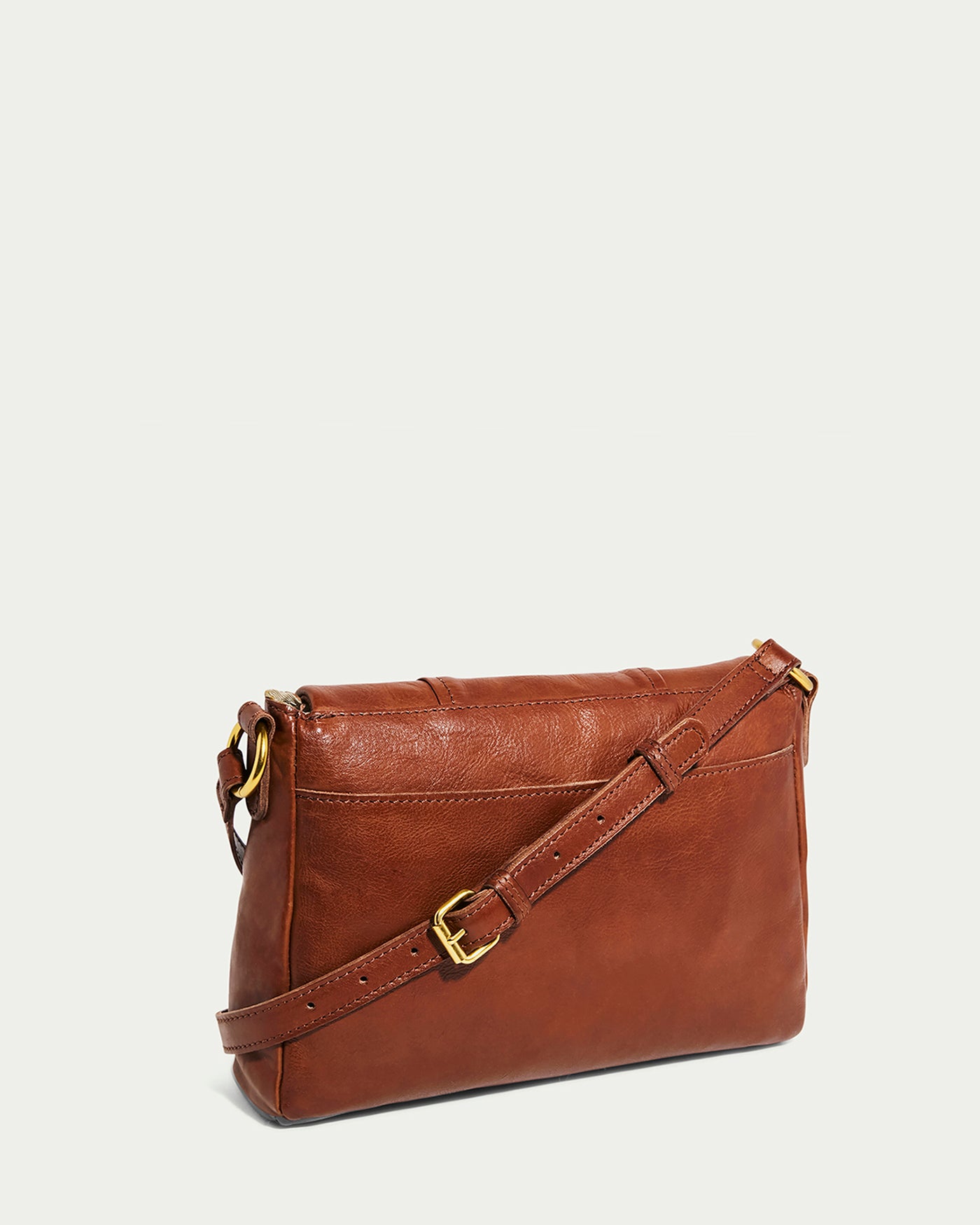 The Lee Double Entry Crossbody by American Leather Co. is a brown genuine leather handbag with a rectangular shape, gold buckle adjustable strap, and smooth texture, all showcased against a plain light background in a minimalist design.