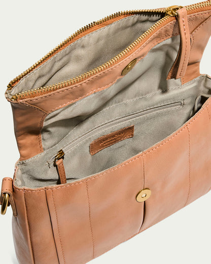 The Lee Double Entry Crossbody by American Leather Co. is an open beige leather crossbody bag featuring a gold zipper and button closure. It has a genuine leather interior with light fabric lining, multiple compartments including a zippered pocket, an adjustable strap, neat stitching, and smooth texture.