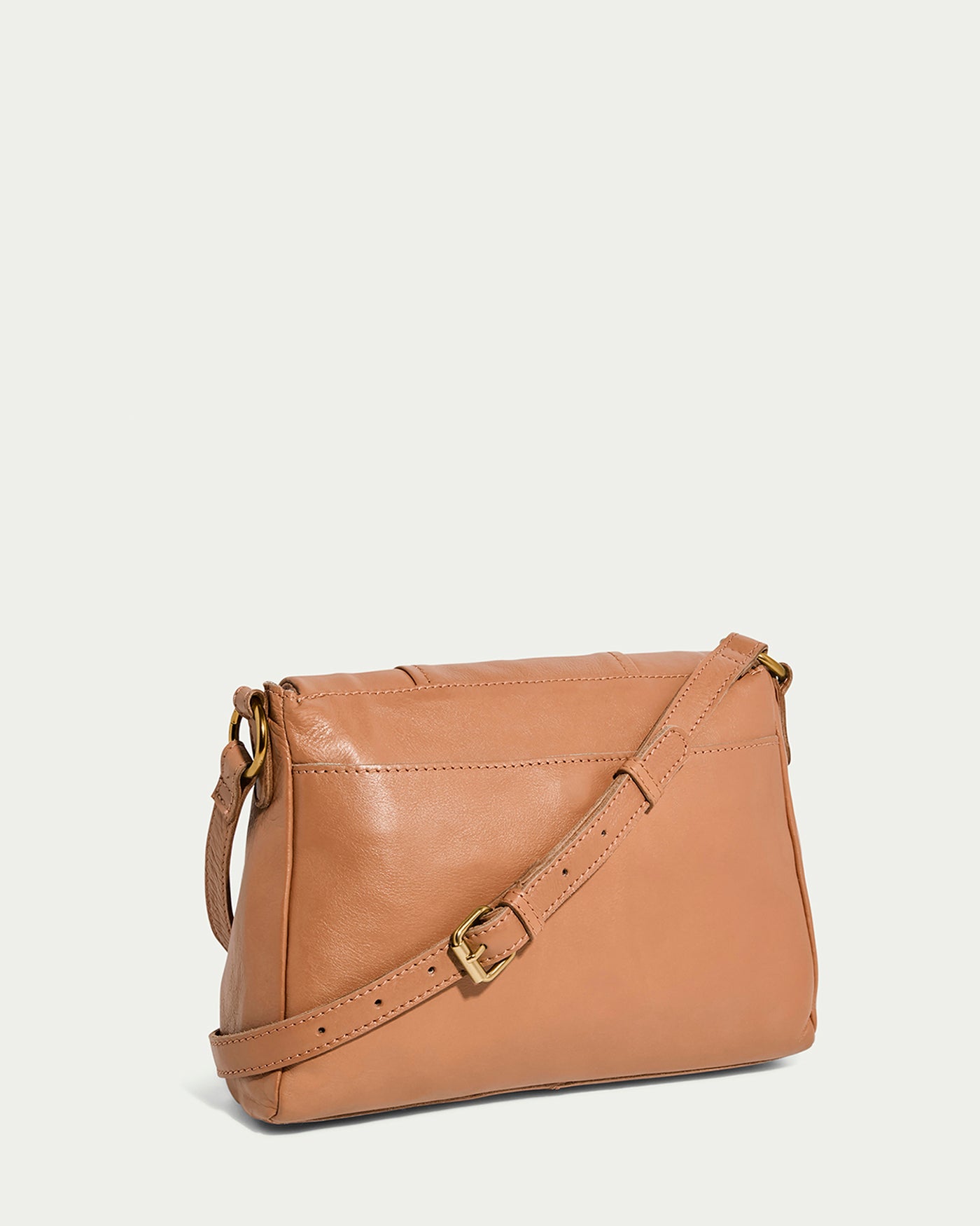 The American Leather Co. Lee Double Entry Crossbody is a genuine leather bag featuring an adjustable strap with a gold buckle. Its smooth texture and simple, elegant design create a chic shoulder or crossbody option, beautifully presented against a plain white background.