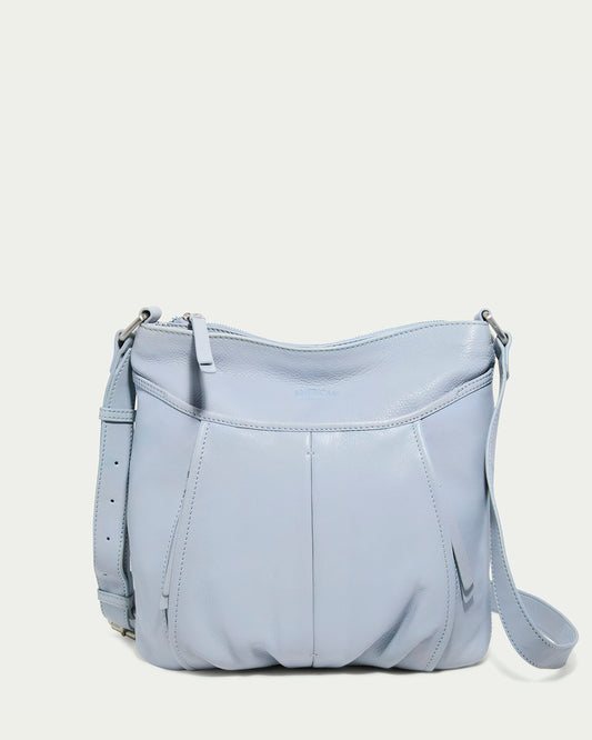 The Lennie Double Entry Crossbody by American Leather Co. in Oasis Blue is a structured leather handbag with an adjustable strap, subtle stitching details, and a zipper closure for a sleek, modern look.