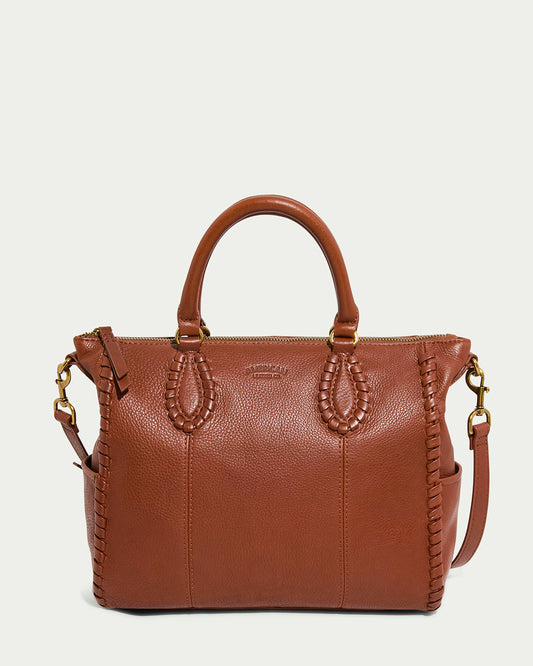 The Madison Satchel by American Leather Co. in brandy features hand-woven detailing, two short handles, a detachable shoulder strap, gold-tone hardware, and a zippered top.