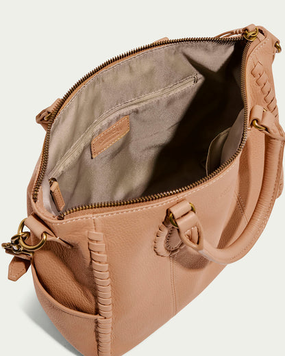 The Madison Satchel by American Leather Co. is a beige glove leather bag with a top zipper opening to its lined interior. It has dual handles, side pockets, hand-woven edging, and elegant brass accents on the handles and zipper.