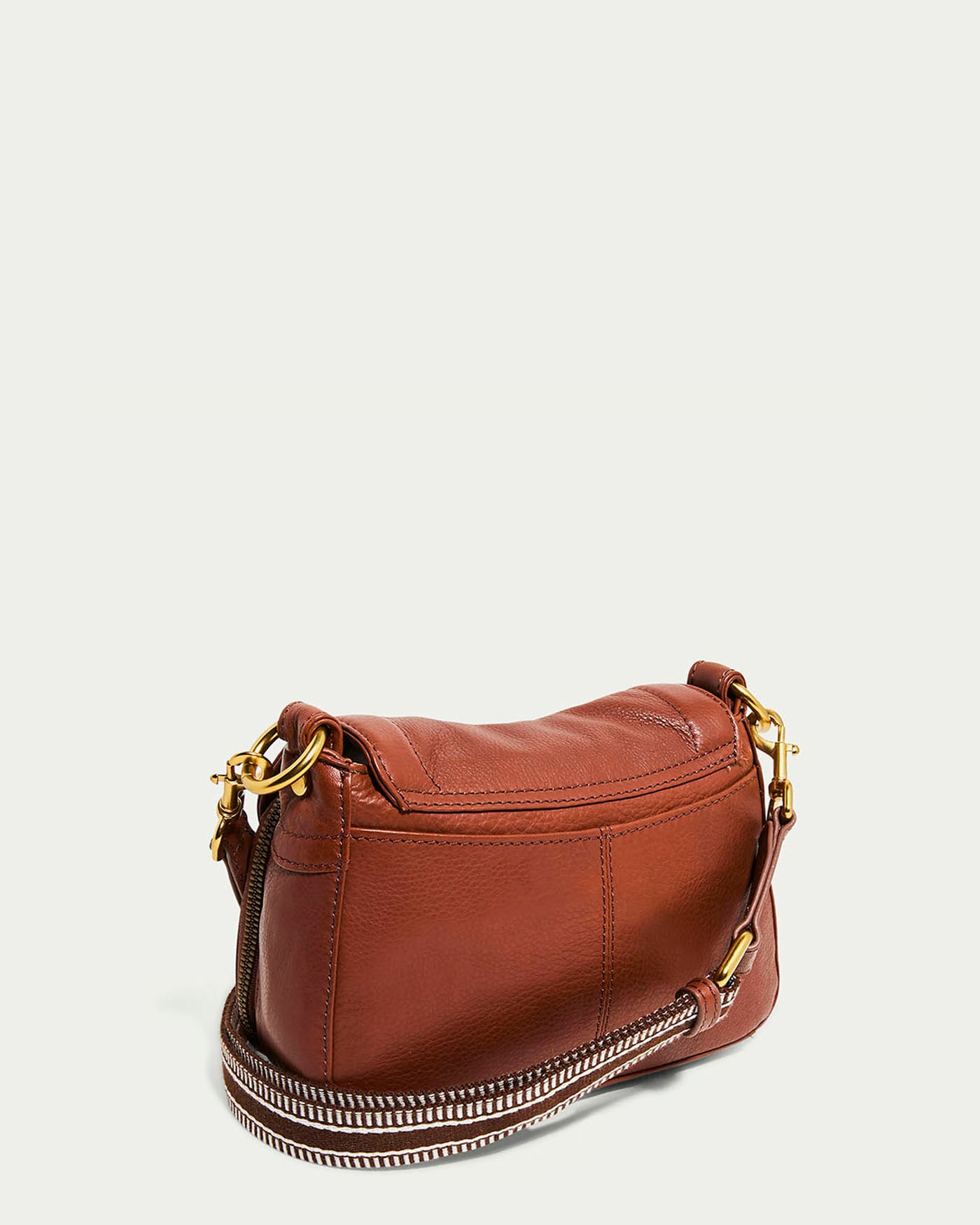 The Marino Mini Crossbody by American Leather Co. is a brown glove leather handbag with gold-tone hardware and an adjustable, removable shoulder strap that combines chain and leather elements. Its simple elegance is showcased against a plain light background.