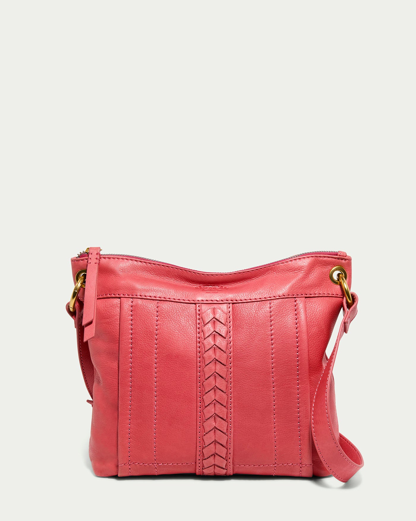 The Sherryl Crossbody by American Leather Co. features a French Rose glove leather exterior with hand-weaving, gold ring attachments, and a crossbody strap. It offers a zipper closure, decorative center stitching, and a textured design that highlights its medium size for an elegant look.