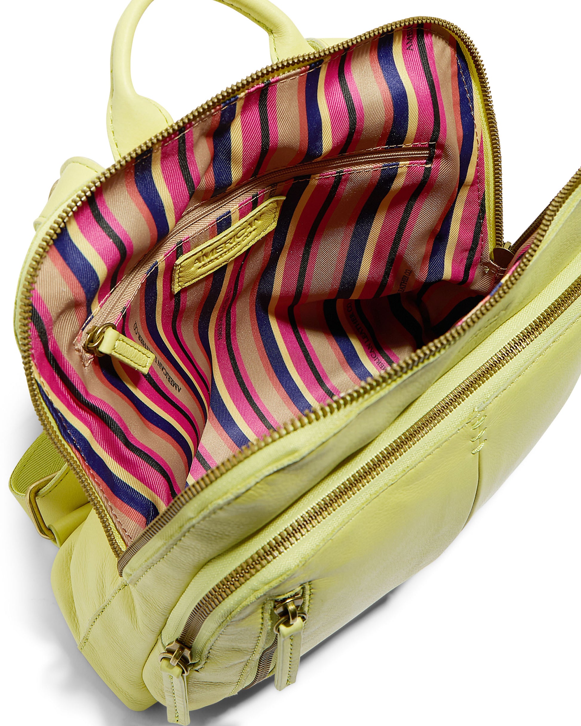 The Cleveland Midsize Backpack by American Leather Co. is small and made of soft, light green genuine leather. When open, it reveals a brightly colored interior with vertical stripes in pink, red, purple, and beige. The bag includes zippered compartments and pockets, one featuring a gold zipper. The exterior also has additional front zip compartments for extra storage.