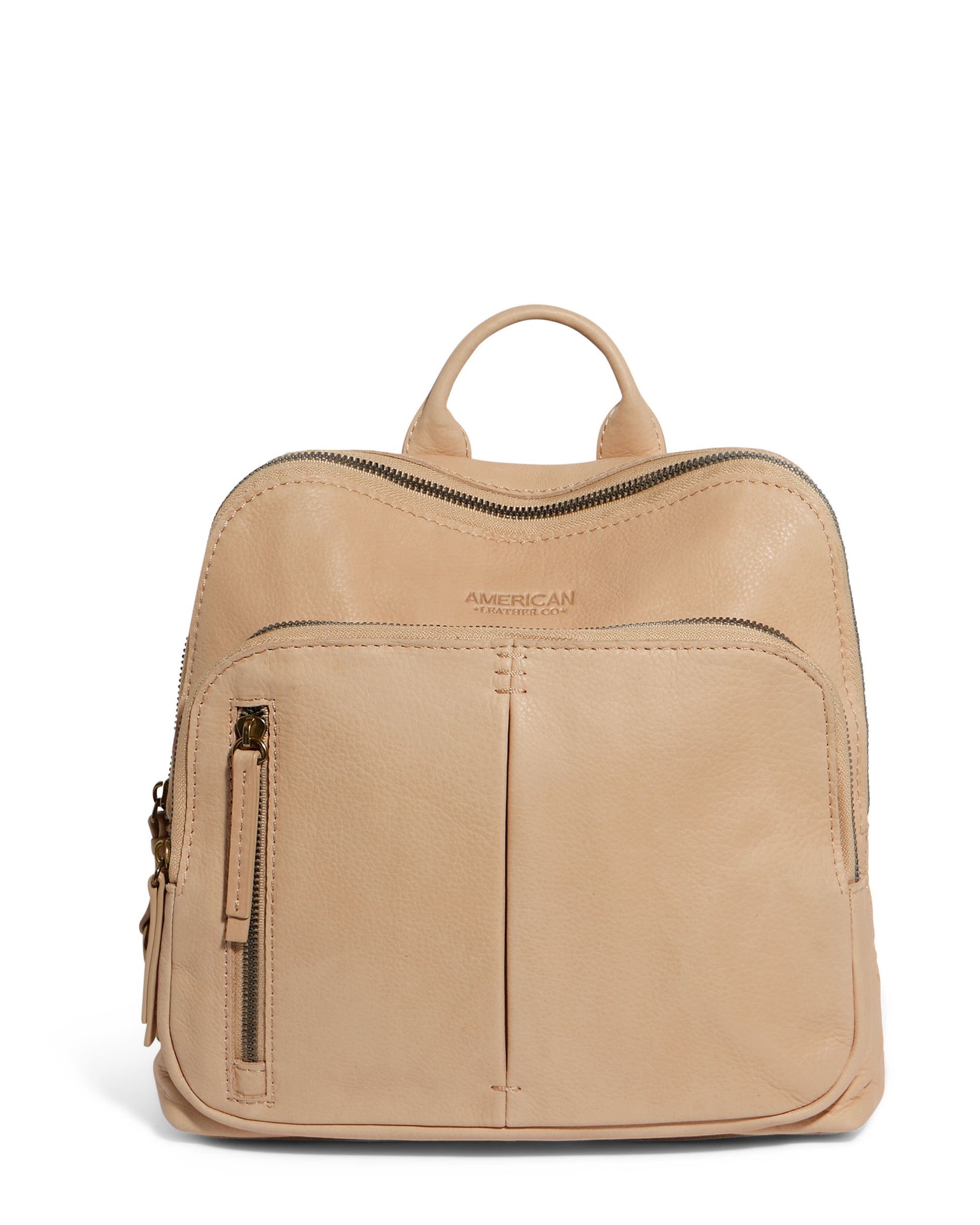 The Cleveland Midsize Backpack by American Leather Co. is a beige genuine leather backpack with a top handle, two zip compartments, and a front pocket featuring a vertical zipper. The brand name is elegantly embossed on the top front.