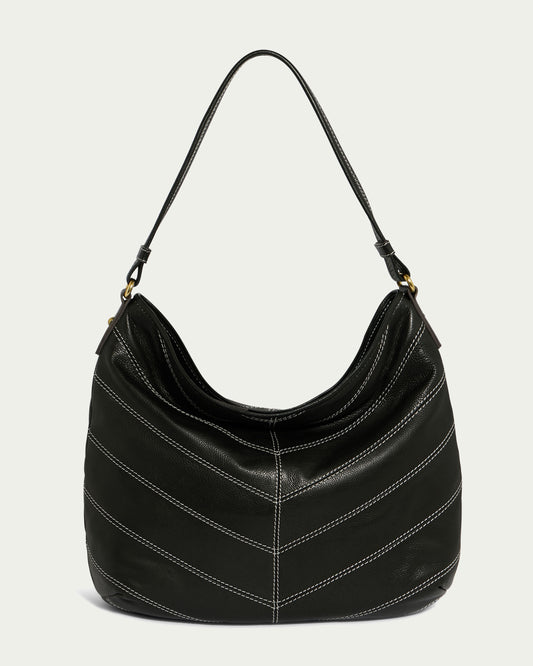 The Raleigh Ziptop Patchwork Hobo by American Leather Co. features a genuine leather design with a single strap and diagonal white stitching details. Its soft, slouchy silhouette offers a spacious interior, complementing the bag's sleek black exterior.