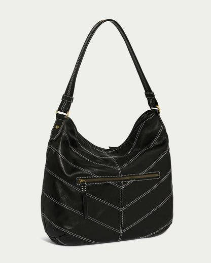 The Raleigh Ziptop Patchwork Hobo by American Leather Co. is a black leather hobo bag with a single strap and decorative white stitching. It has a front zip pocket, a chevron patchwork design, and is accented with gold-tone hardware for an elegant touch.