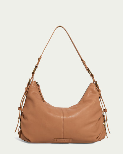 The Thayer Perfect Hobo by American Leather Co. is a tan leather purse with a single shoulder strap and side buckle details, made from genuine leather with a relaxed, slouchy shape and smooth texture.