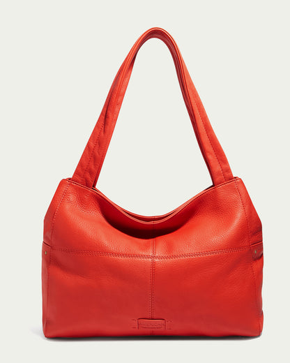 Meet the Virginia Tote by American Leather Co., a chic red handbag made from high-quality calf leather. This sophisticated piece showcases two handles and boasts a sleek, minimalist aesthetic with delicate stitching and a smooth finish, beautifully highlighted against a simple light backdrop.