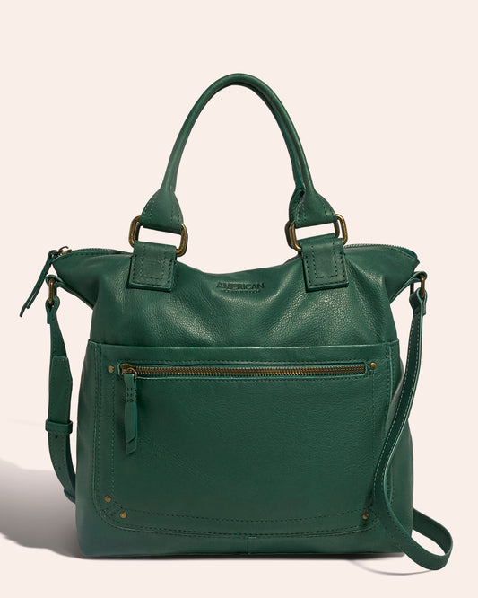 Introducing the Jamestown Tote by American Leather Co.—a beautifully crafted green leather tote featuring two handles and an adjustable shoulder strap made from genuine American leather. It boasts a front zippered pocket with a tassel pull and subtle metal accents, elegantly showcased against a neutral background.